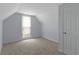 Bedroom featuring neutral carpet, gray walls, a window, and white door at 524 S State St, Greenfield, IN 46140