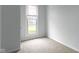 Bright bedroom with carpet floors, light gray paint, and natural light from a window at 524 S State St, Greenfield, IN 46140
