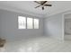 Spacious bedroom with light tile flooring, a ceiling fan and bright natural light at 524 S State St, Greenfield, IN 46140