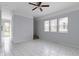 Bright bedroom with tiled floors, three windows and a ceiling fan at 524 S State St, Greenfield, IN 46140