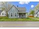 Charming two-story home with a covered front porch and light blue siding at 524 S State St, Greenfield, IN 46140