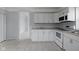 Kitchen with white cabinets, marble countertop, tiled floors and modern appliances at 524 S State St, Greenfield, IN 46140