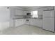 Kitchen with white cabinets, white appliances and tiled floor at 524 S State St, Greenfield, IN 46140