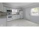 Kitchen with white cabinets, appliances and tiled floor at 524 S State St, Greenfield, IN 46140