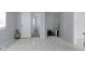 View of the living room with marble floors, showing the entrances to the laundry and bathroom at 524 S State St, Greenfield, IN 46140