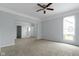 Spacious main bedroom with carpet floors, ceiling fan, light gray paint, and three doors at 524 S State St, Greenfield, IN 46140