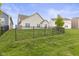 Well-maintained backyard featuring a lush lawn and a secure black metal fence at 5423 Maywood Dr, Whitestown, IN 46075