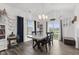 Formal dining area featuring a modern table, elegant chandelier, and natural light at 5423 Maywood Dr, Whitestown, IN 46075