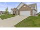 View of the home's facade, driveway, and manicured lawn from the side at 5423 Maywood Dr, Whitestown, IN 46075