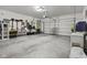 Well-lit two-car garage with epoxy flooring and convenient storage solutions at 5423 Maywood Dr, Whitestown, IN 46075