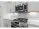 Close up of the gourmet kitchen features stainless steel microwave and stove at 5423 Maywood Dr, Whitestown, IN 46075