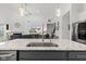 Bright kitchen island with modern faucet, seamlessly flowing into the spacious living area at 5423 Maywood Dr, Whitestown, IN 46075