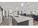 Open concept: kitchen island with granite counters and dining area with high ceilings and natural lighting at 5423 Maywood Dr, Whitestown, IN 46075