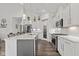 An airy kitchen with stainless steel appliances, island, quartz countertops, and modern cabinetry at 5423 Maywood Dr, Whitestown, IN 46075