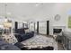 Open-concept living room featuring a fireplace, large windows, and cozy seating at 5423 Maywood Dr, Whitestown, IN 46075