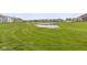 Scenic view of the community pond surrounded by lush green lawns and well-kept homes at 5423 Maywood Dr, Whitestown, IN 46075