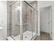 Modern bathroom shower with sleek tile, glass enclosure, and rainfall showerhead at 5423 Maywood Dr, Whitestown, IN 46075