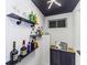 Basement bar with open shelving showcases barware and liquor in a stylish setting at 5707 S Burlington Dr, Muncie, IN 47302