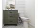 Charming bathroom with olive-green vanity and stylish tiling at 5707 S Burlington Dr, Muncie, IN 47302