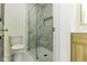Modern bathroom features marble-tiled walls, glass shower doors, and stylish gold fixtures at 5707 S Burlington Dr, Muncie, IN 47302