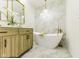 Bathroom showcasing a modern soaking tub, vanity, and marble tile at 5707 S Burlington Dr, Muncie, IN 47302