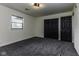 Neutral bedroom featuring carpeting, a window, closet and attached door at 5707 S Burlington Dr, Muncie, IN 47302