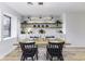 Dining area with modern lighting, white walls, display shelves, and wood-look flooring at 5707 S Burlington Dr, Muncie, IN 47302