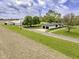 Expansive property featuring a charming home, detached garage and barn, all set against a picturesque landscape with mature trees at 5707 S Burlington Dr, Muncie, IN 47302