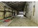 Rustic garage interior with a roll-up door and weathered wood paneling at 5707 S Burlington Dr, Muncie, IN 47302
