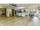 Open-concept kitchen with white cabinets, stainless steel appliances, large island, and wood-look flooring at 5707 S Burlington Dr, Muncie, IN 47302