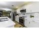 Well-equipped kitchen with white cabinets, stainless steel appliances, and modern backsplash at 5707 S Burlington Dr, Muncie, IN 47302
