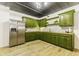 This kitchen boasts unique green cabinets and stainless steel appliances at 5707 S Burlington Dr, Muncie, IN 47302