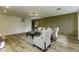 Cozy living room with a modern wood-slat accent wall, neutral furniture, and wood-look flooring at 5707 S Burlington Dr, Muncie, IN 47302