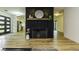 Living room featuring a brick fireplace, hardwood floors, and an open floor plan at 5707 S Burlington Dr, Muncie, IN 47302