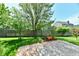 Private backyard with brick patio, lush greenery, and wooden fence, perfect for relaxation at 5809 Scotland St, Indianapolis, IN 46234