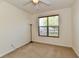 Comfortable bedroom featuring a ceiling fan and a large window with blinds at 5809 Scotland St, Indianapolis, IN 46234