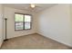 Bright bedroom with a ceiling fan and a window offering natural light at 5809 Scotland St, Indianapolis, IN 46234