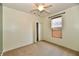 Neutral bedroom features a ceiling fan, closet, and window allowing for lots of natural light at 5809 Scotland St, Indianapolis, IN 46234