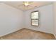 Neutral bedroom features a ceiling fan and window allowing for lots of natural light at 5809 Scotland St, Indianapolis, IN 46234