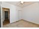 Empty carpeted bedroom with a ceiling fan and a closet at 5809 Scotland St, Indianapolis, IN 46234