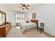 Carpeted bedroom with wood accents, ceiling fan, and natural light at 5809 Scotland St, Indianapolis, IN 46234