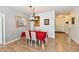 Bright dining room features a red tablecloth, hanging light fixture, and wood flooring at 5809 Scotland St, Indianapolis, IN 46234