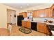 Well-lit kitchen featuring oak cabinets, modern black appliances, and tile floors at 5809 Scotland St, Indianapolis, IN 46234