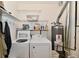 Convenient laundry area with modern washer and dryer units and shelving at 5809 Scotland St, Indianapolis, IN 46234
