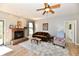 Cozy living room featuring a brick fireplace and a ceiling fan at 5809 Scotland St, Indianapolis, IN 46234