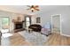 Comfortable living room with a fireplace, ceiling fan, and neutral color scheme at 5809 Scotland St, Indianapolis, IN 46234