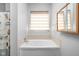Relaxing bathroom with a large soaking tub, privacy window, and stylish shell-themed shower curtain at 5864 Mustang Ter, Plainfield, IN 46168