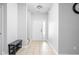 Bright entryway with tile floors, a white front door and a gray bench with shoe rack at 5864 Mustang Ter, Plainfield, IN 46168