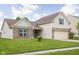 Side view of a well-maintained, two-story home with a manicured lawn and a two-car garage on a sunny day at 5864 Mustang Ter, Plainfield, IN 46168