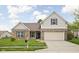 Charming brick and siding home with a well-maintained lawn and a two-car garage in a suburban neighborhood at 5864 Mustang Ter, Plainfield, IN 46168
